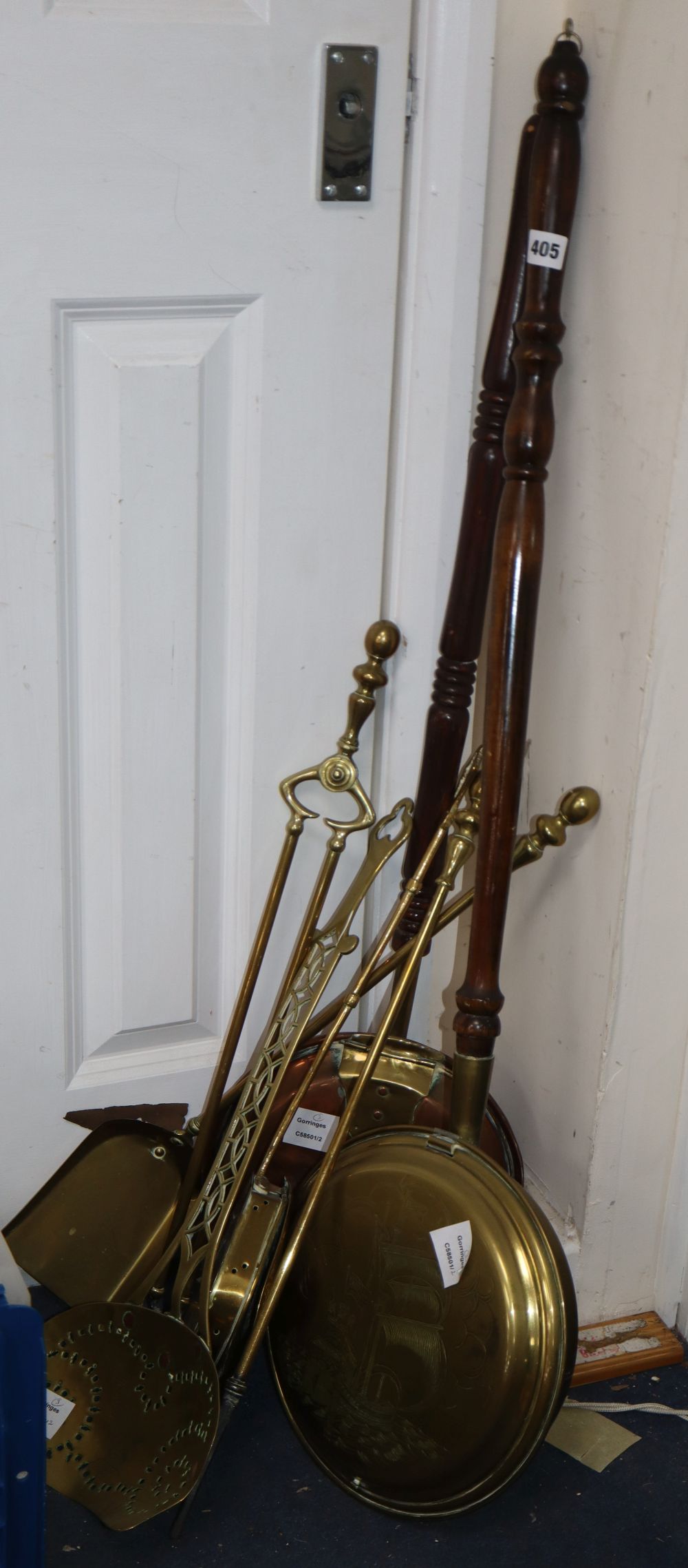 A Victorian copper warming pan, a modern brass warming pan and an early 19th century brass cream skimmer (3)